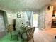Casual dining area with a glass table and comfortable seating for four at 2760 Chipley Ave, North Port, FL 34286