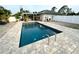 Large rectangular pool with paver deck and surrounding landscaping at 2760 Chipley Ave, North Port, FL 34286