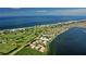 Stunning aerial view of coastal homes, golf course, and oceanfront property with pristine beach at 360 Gulf Of Mexico Dr # 322, Longboat Key, FL 34228