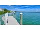 Waterfront dock with benches providing a tranquil spot to enjoy the beautiful blue waters at 360 Gulf Of Mexico Dr # 322, Longboat Key, FL 34228