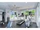 Well-equipped gym with cardio machines, weights, and natural light from large windows at 360 Gulf Of Mexico Dr # 322, Longboat Key, FL 34228