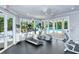 Community fitness center features cardio equipment, natural light, and a beautiful view of the pool at 360 Gulf Of Mexico Dr # 322, Longboat Key, FL 34228