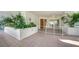This lovely tiled patio features lush plants, a white fence, and access to the interior through glass doors at 360 Gulf Of Mexico Dr # 322, Longboat Key, FL 34228
