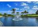 Beautiful pond with fountain, surrounded by lush greenery and palm trees on a sunny day at 360 Gulf Of Mexico Dr # 322, Longboat Key, FL 34228