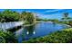 Scenic pond with white swans and fountain with surrounding gardens and a building in the background at 360 Gulf Of Mexico Dr # 322, Longboat Key, FL 34228