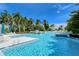 Large community pool with ample lounge seating and lush landscaping creating a resort-like atmosphere at 360 Gulf Of Mexico Dr # 322, Longboat Key, FL 34228