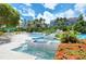 Resort-style pool area with lounge chairs, lush tropical landscaping, and beautiful water features at 360 Gulf Of Mexico Dr # 322, Longboat Key, FL 34228