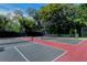 Outdoor tennis courts, shaded by trees, provide an excellent amenity for active residents at 360 Gulf Of Mexico Dr # 322, Longboat Key, FL 34228