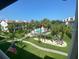 A view of the community pool, lush landscaping, and surrounding buildings at 324 Madeira Cir, Tierra Verde, FL 33715