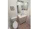 Functional bathroom with a vanity, mirror, and a toilet, offering a clean and practical design at 324 Madeira Cir, Tierra Verde, FL 33715