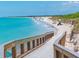 Beautiful beach with crystal blue water, a sandy shoreline, and a wooden boardwalk at 324 Madeira Cir, Tierra Verde, FL 33715