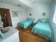 Inviting guest bedroom with twin beds, wood floors, and coastal-inspired accents at 324 Madeira Cir, Tierra Verde, FL 33715