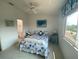 Bright bedroom with nautical decor, a window, and a view of the home's exterior at 324 Madeira Cir, Tierra Verde, FL 33715