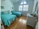 A charming bedroom featuring two twin beds, natural light, and a classic dresser at 324 Madeira Cir, Tierra Verde, FL 33715