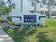 Entrance sign for The Palms of Tierra community surrounded by manicured landscaping at 324 Madeira Cir, Tierra Verde, FL 33715
