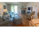 Inviting living room with wood floors, fireplace, and adjacent dining area at 324 Madeira Cir, Tierra Verde, FL 33715