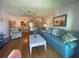 Comfortable living room with hardwood floors, ceiling fan, and open concept design at 324 Madeira Cir, Tierra Verde, FL 33715