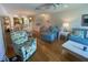 Bright living room with neutral walls, wood floors, and comfortable blue furniture set at 324 Madeira Cir, Tierra Verde, FL 33715