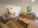 Bright living room area with a couch, coffee table, seating, and beach themed decor at 324 Madeira Cir, Tierra Verde, FL 33715