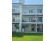 Townhome with private patio, grassy area, and AC units at 324 Madeira Cir, Tierra Verde, FL 33715