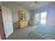 Spacious bedroom with a dresser and access to a private balcony at 324 Madeira Cir, Tierra Verde, FL 33715