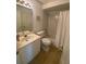 Clean bathroom with tub, single sink vanity and tiled floor at 324 Madeira Cir, Tierra Verde, FL 33715