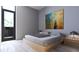 Bright bedroom featuring a platform bed and large artwork at 2170 Robinhood Street # C2-302, Sarasota, FL 34231