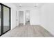 Spacious bedroom with wood-look floors and access to bathroom at 4549 Targee Ave, North Port, FL 34287