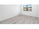 Simple bedroom with wood-look floors and a window at 4549 Targee Ave, North Port, FL 34287