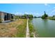 Backyard featuring a seawall, green grass, and view of a canal at 1260 Lakeside Dr, Venice, FL 34293