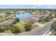 Aerial view of a home with a well-manicured lawn and a pond behind the property in a desirable neighborhood at 6309 75Th E Ave, Palmetto, FL 34221