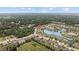 An aerial view of a home nestled near a serene pond surrounded by lush greenery at 6309 75Th E Ave, Palmetto, FL 34221