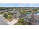Scenic aerial view of a community home nestled beside a tranquil pond and mature trees at 6309 75Th E Ave, Palmetto, FL 34221