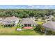 Spacious backyard with green lawn, patio, fire pit, and secure black metal fence at 6309 75Th E Ave, Palmetto, FL 34221