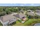 Aerial view of the backyard featuring a deck, fire pit, and lush green lawn at 6309 75Th E Ave, Palmetto, FL 34221