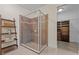 Bathroom featuring a glass-enclosed shower with tiled walls and a shelving unit at 6309 75Th E Ave, Palmetto, FL 34221