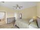 Well-lit bedroom with wood-look floors, ceiling fan, and neutral décor at 6309 75Th E Ave, Palmetto, FL 34221