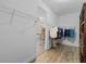 Walk-in closet leading to the bathroom featuring built in shelves and hanging racks at 6309 75Th E Ave, Palmetto, FL 34221