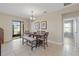 Elegant dining room with tiled floor, backyard view, and stylish light fixture at 6309 75Th E Ave, Palmetto, FL 34221