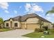 Charming single-story home with an attached two-car garage, a well-maintained lawn, and mature landscaping at 6309 75Th E Ave, Palmetto, FL 34221