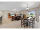 Bright living room boasts a large television, decorative furniture, and outdoor views at 6309 75Th E Ave, Palmetto, FL 34221