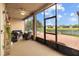Relaxing screened-in patio overlooking the backyard, offering comfortable seating and serene water views at 6309 75Th E Ave, Palmetto, FL 34221