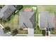Overhead shot of home with gray roof, well-maintained lawn, and trees around the perimeter at 6309 75Th E Ave, Palmetto, FL 34221