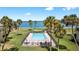 Community pool with ocean view and palm trees at 4660 Ocean Blvd # Q2, Sarasota, FL 34242