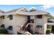 Tan building exterior with stairs and shutters at 4660 Ocean Blvd # Q2, Sarasota, FL 34242