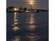 Sailboat at night in calm water under the moonlight at 1623 Pelican Cove Rd # 226, Sarasota, FL 34231