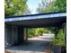 A covered carport with two storage rooms, access to the backyard, and lots of light at 5023 Inverness Dr, Sarasota, FL 34243