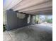 Covered carport featuring access to the home, glass block accents, and views of the backyard at 5023 Inverness Dr, Sarasota, FL 34243