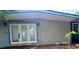 Exterior view of home with a combination of concrete block and vertical wood siding and newer doors at 5023 Inverness Dr, Sarasota, FL 34243