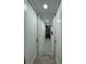 Hallway with modern lighting, painted white doors, and a stylish black and white runner at 5023 Inverness Dr, Sarasota, FL 34243